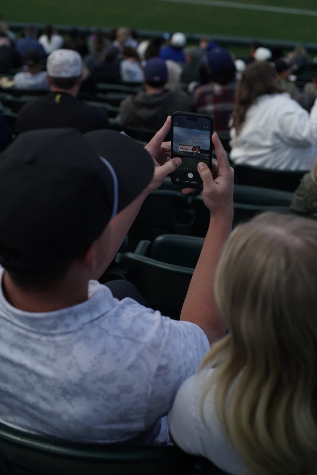 Fan scanning the stadium jumbotron to join Agave
